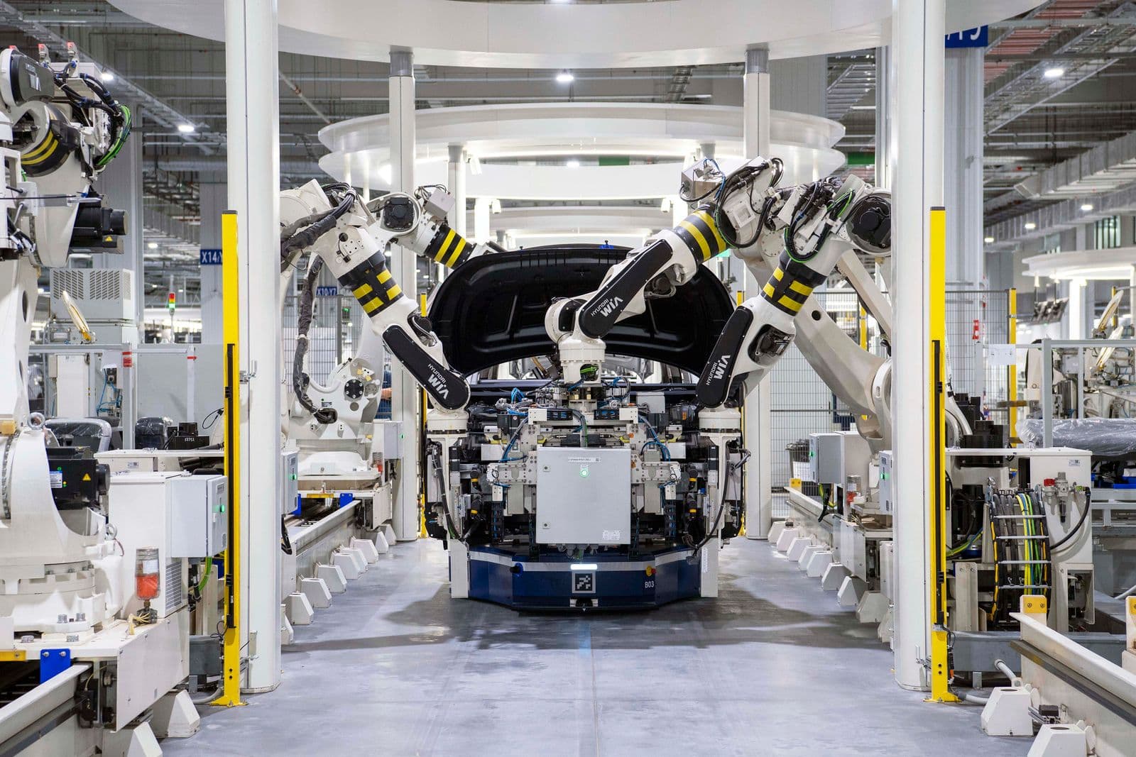 Robotic arms assembling a vehicle body on a modern automotive production line
